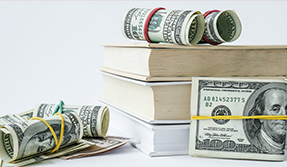 money and stack of books