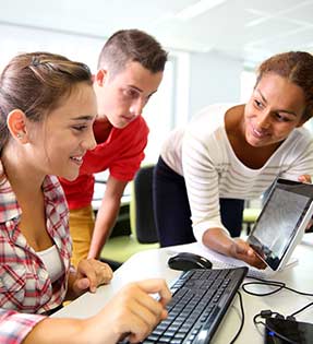 Three students work on computers