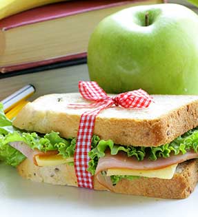 Sandwich, apple and books