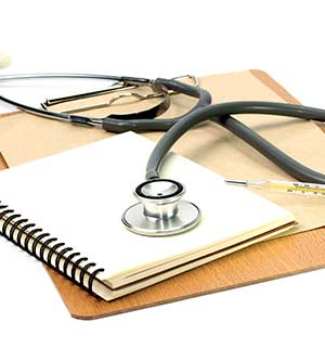 Clipboard, notebook, thermometer and stethoscope
